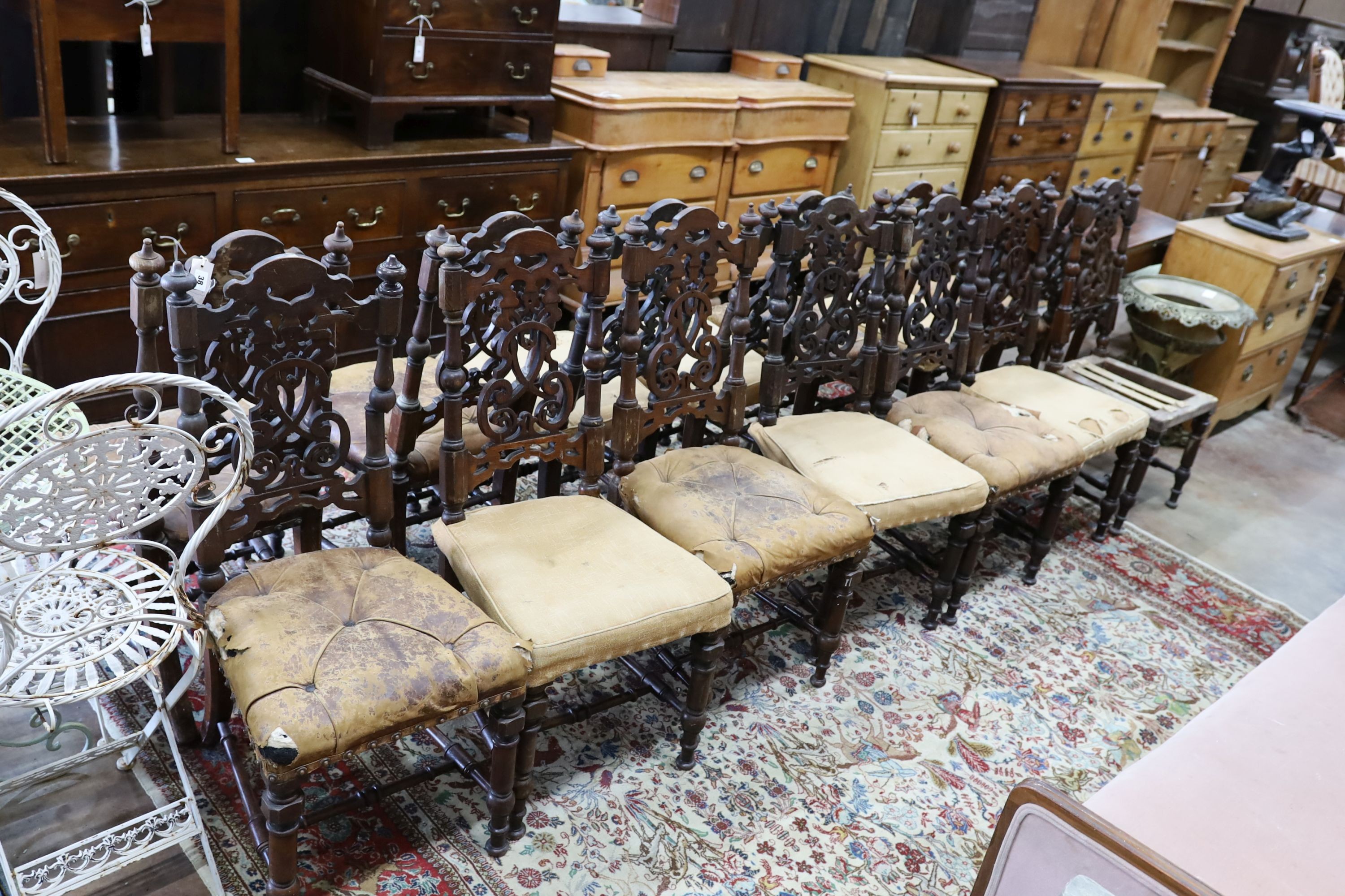 A set of fourteen 19th century Continental carved oak dining chairs